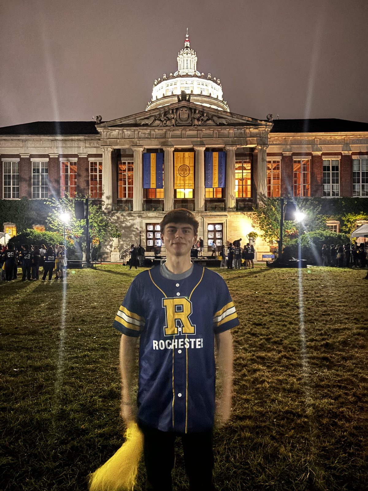 Jackson Wimpsett in a Rochester jersey in front of Rush Rhees Library at the University of Rochester